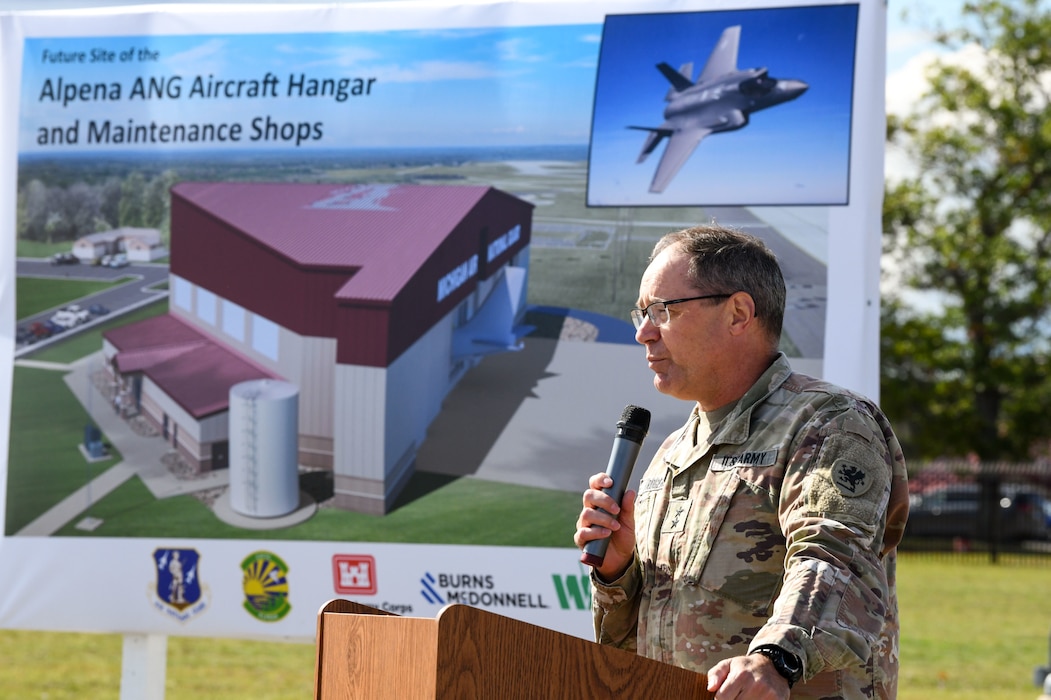 Two-star Army general in uniform stands at podium.