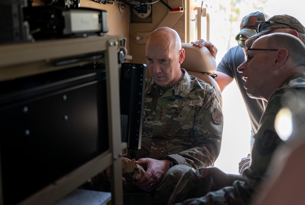 Air Force Chief of Staff Gen. David Allvin examines the controls of a Recovery of Airbase Denied by Ordnance system