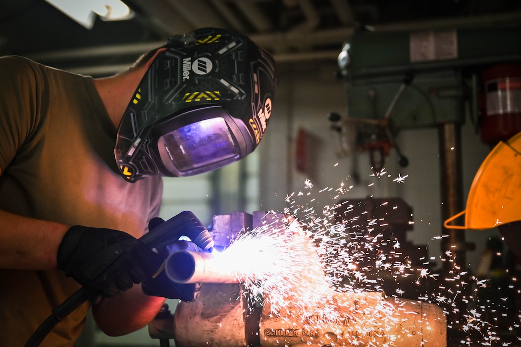 Tech Sgt. Cody Williamson, heavy mobile equipment mechanic with the 155th Logistics Readiness Squadron, uses a plasma cutter to cut excess material