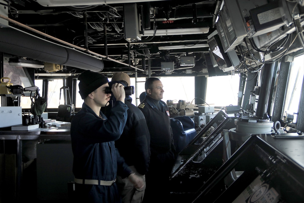 Cmdr. Jordan Stutzman, Ensign Cameron Brewer and Lt. Charles Ward stand watch on the bridge aboard USS McCampbell (DDG 85) in the vicinity of the Northern Kuril Islands.