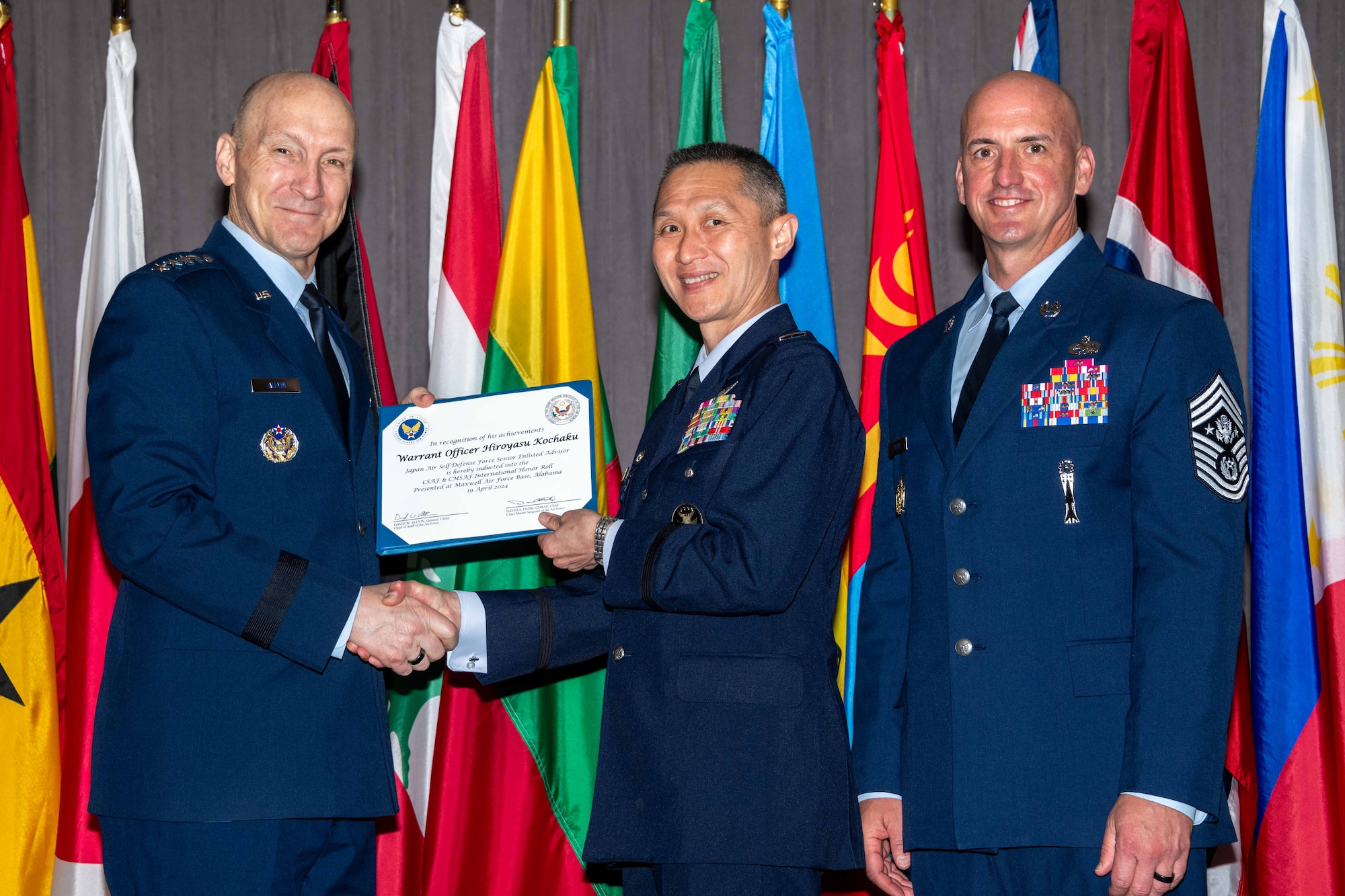 Air Force Chief of Staff Gen. David Allvin and Chief Master Sergeant of the Air Force David Flosi induct Warrant Officer Hiroyasu Kochaku, Senior Enlisted Advisor Koku-Jietai (Japan Air Self-Defense Force), into the 2024 CSAF & CMSAF International Honor Roll at Maxwell Air Force Base, Ala., Apr. 19, 2024. International Honor Roll recognizes former Air University students who rose to the equivalent level of Chief of Staff or higher or Chief Master Sergeant of the Air Force or higher in their respective services. (US Air Force photo by Melanie Rodgers Cox)