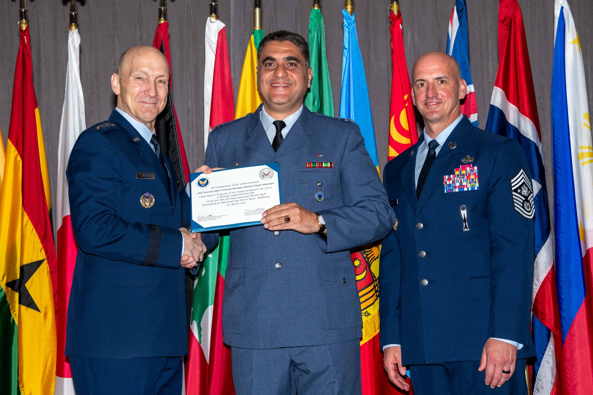 Air Force Chief of Staff Gen. David Allvin and Chief Master Sergeant of the Air Force David Flosi induct Chief Warrant Officer (retired) Mowafaq Mansour Diyab Almustafa, Chief Master Sergeant of the Royal Jordanian Air Force, into the 2024 CSAF & CMSAF International Honor Roll at Maxwell Air Force Base, Ala., Apr. 19, 2024. International Honor Roll recognizes former Air University students who rose to the equivalent level of Chief of Staff or higher or Chief Master Sergeant of the Air Force or higher in their respective services. (US Air Force photo by Melanie Rodgers Cox)