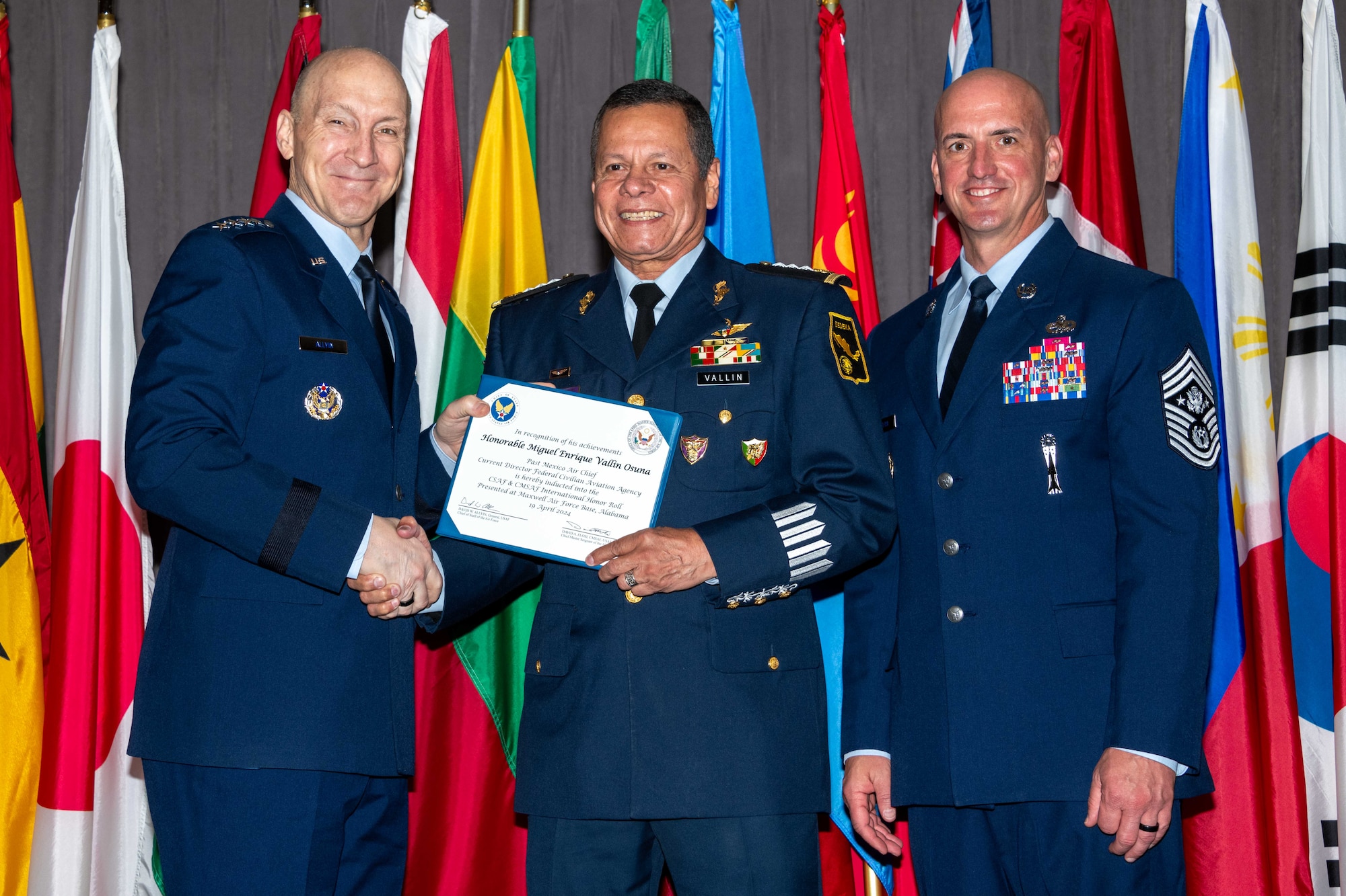 Air Force Chief of Staff Gen. David Allvin and Chief Master Sergeant of the Air Force David Flosi induct Honorable (Div Gen ret) Miguel Enrique Vallin Osuna, former Mexico Air Chief, current Director Federal Civilian Aviation Agency, into the 2024 CSAF & CMSAF International Honor Roll at Maxwell Air Force Base, Ala., Apr. 19, 2024. International Honor Roll recognizes former Air University students who rose to the equivalent level of Chief of Staff or higher or Chief Master Sergeant of the Air Force or higher in their respective services. (US Air Force photo by Melanie Rodgers Cox)