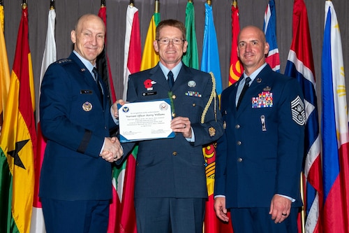 Air Force Chief of Staff Gen. David Allvin and Chief Master Sergeant of the Air Force David Flosi induct Warrant Officer Kerry Williams, Warrant Officer of the Air Force, New Zealand, into the 2024 CSAF & CMSAF International Honor Roll at Maxwell Air Force Base, Ala., Apr. 19, 2024. International Honor Roll recognizes former Air University students who rose to the equivalent level of Chief of Staff or higher or Chief Master Sergeant of the Air Force or higher in their respective services. (US Air Force photo by Melanie Rodgers Cox)