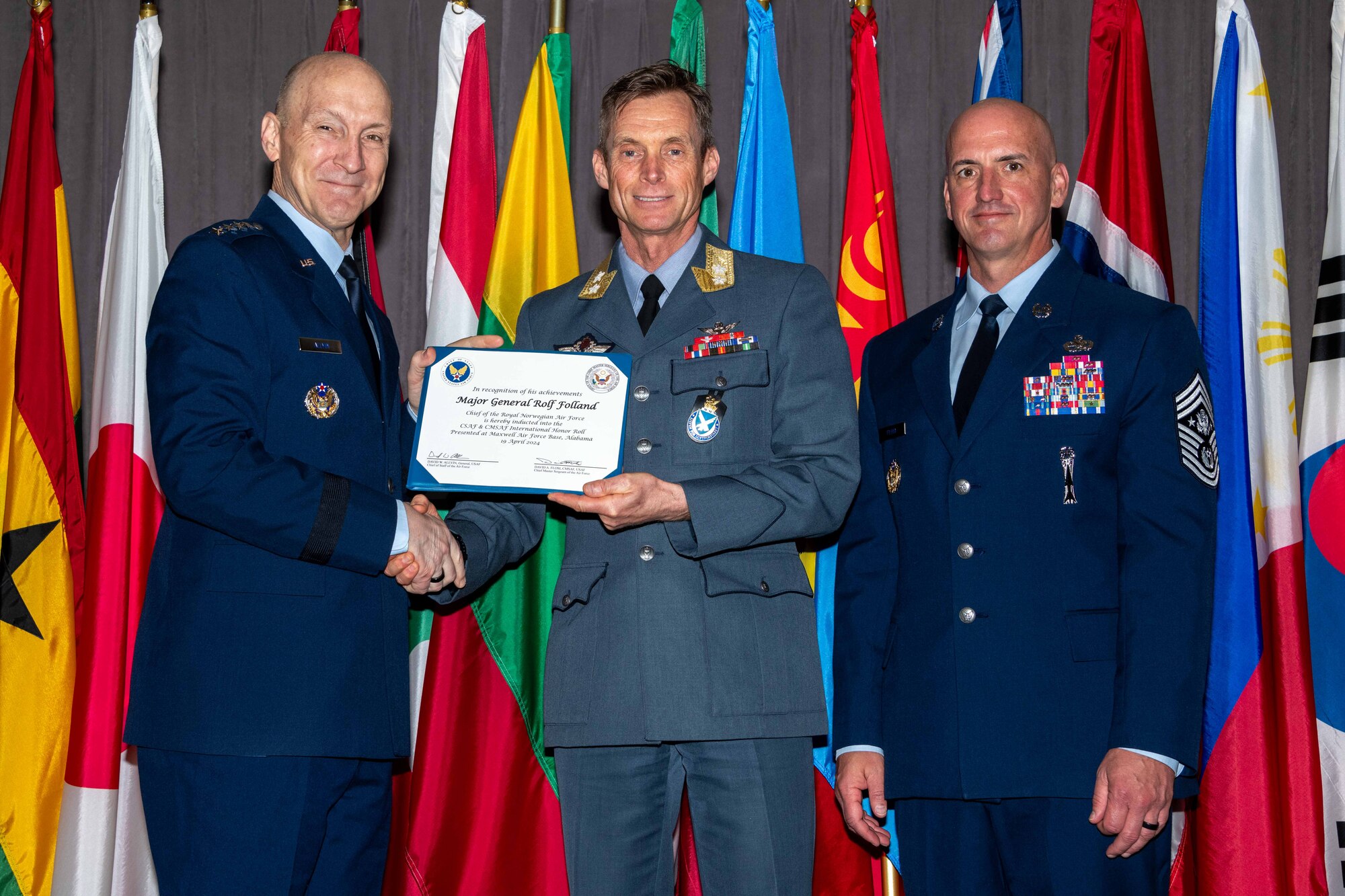Air Force Chief of Staff Gen. David Allvin and Chief Master Sergeant of the Air Force David Flosi induct Maj. Gen. Rolf Folland, Chief of the Royal Norwegian Air Force, into the 2024 CSAF & CMSAF International Honor Roll at Maxwell Air Force Base, Ala., Apr. 19, 2024. International Honor Roll recognizes former Air University students who rose to the equivalent level of Chief of Staff or higher or Chief Master Sergeant of the Air Force or higher in their respective services. (US Air Force photo by Melanie Rodgers Cox)