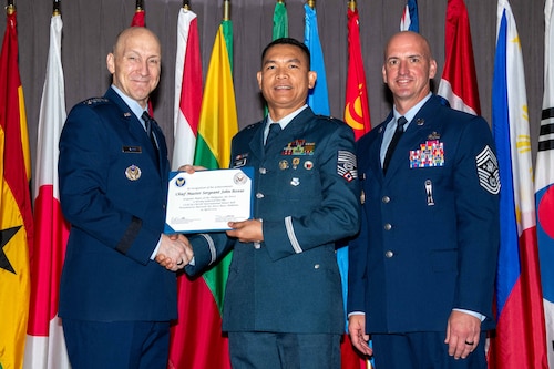 Air Force Chief of Staff Gen. David Allvin and Chief Master Sergeant of the Air Force David Flosi induct Chief Master Sgt. John Roxas, Sergeant Major of the Philippine Air Force, into the 2024 CSAF & CMSAF International Honor Roll at Maxwell Air Force Base, Ala., Apr. 19, 2024. International Honor Roll recognizes former Air University students who rose to the equivalent level of Chief of Staff or higher or Chief Master Sergeant of the Air Force or higher in their respective services. (US Air Force photo by Melanie Rodgers Cox)
