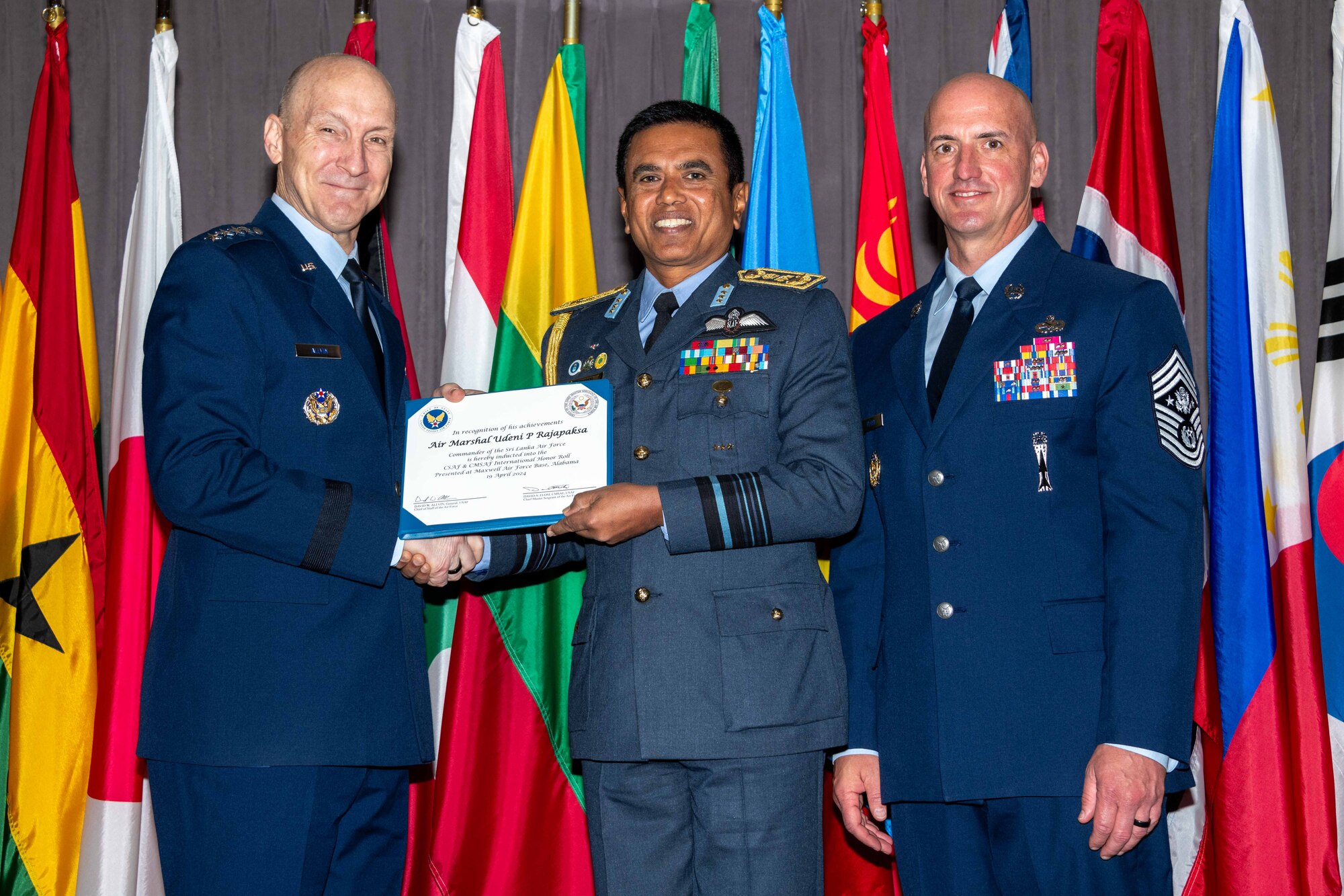 Air Force Chief of Staff Gen. David Allvin and Chief Master Sergeant of the Air Force David Flosi induct Air Marshal Udeni P Rajapaksa, Commander of Sri Lankan Air Force, into the 2024 CSAF & CMSAF International Honor Roll at Maxwell Air Force Base, Ala., Apr. 19, 2024. International Honor Roll recognizes former Air University students who rose to the equivalent level of Chief of Staff or higher or Chief Master Sergeant of the Air Force or higher in their respective services. (US Air Force photo by Melanie Rodgers Cox)