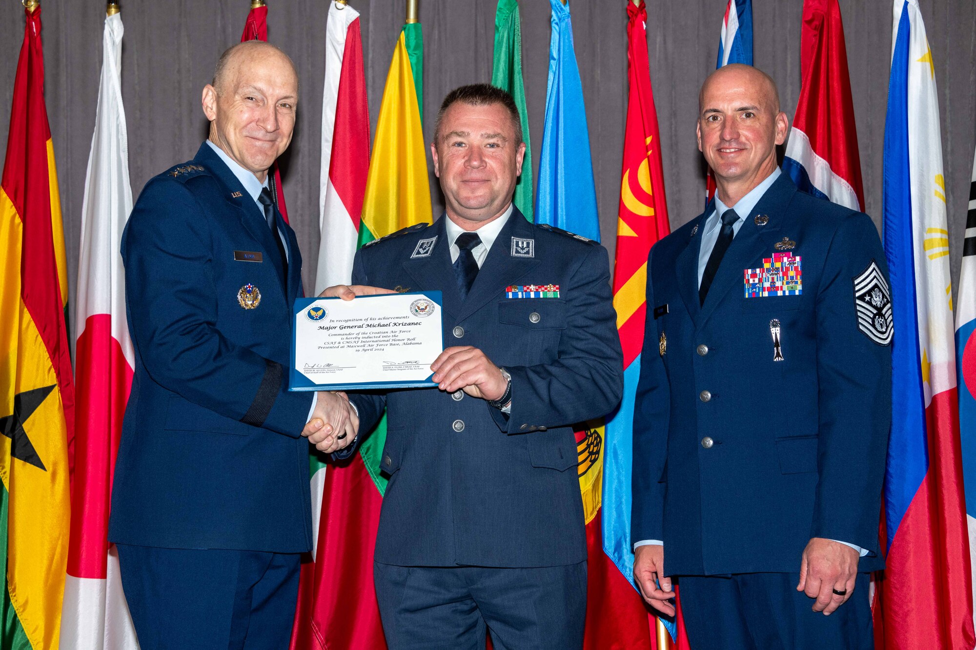 Air Force Chief of Staff Gen. David Allvin and Chief Master Sergeant of the Air Force David Flosi induct Maj. Gen. Michael Križanec, Commander, Croatian Air Force, into the 2024 CSAF & CMSAF International Honor Roll at Maxwell Air Force Base, Ala., Apr. 19, 2024. International Honor Roll recognizes former Air University students who rose to the equivalent level of Chief of Staff or higher or Chief Master Sergeant of the Air Force or higher in their respective services. (US Air Force photo by Melanie Rodgers Cox)