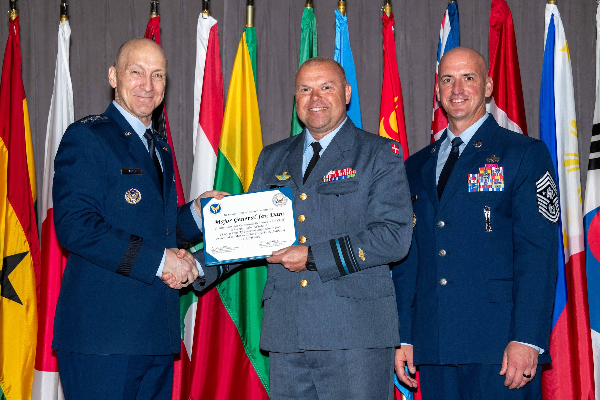 Air Force Chief of Staff Gen. David Allvin and Chief Master Sergeant of the Air Force David Flosi induct Maj. Gen. Jan Dam, Commander Air Command Denmark, into the 2024 CSAF & CMSAF International Honor Roll at Maxwell Air Force Base, Ala., Apr. 19, 2024. International Honor Roll recognizes former Air University students who rose to the equivalent level of Chief of Staff or higher or Chief Master Sergeant of the Air Force or higher in their respective services. (US Air Force photo by Melanie Rodgers Cox)