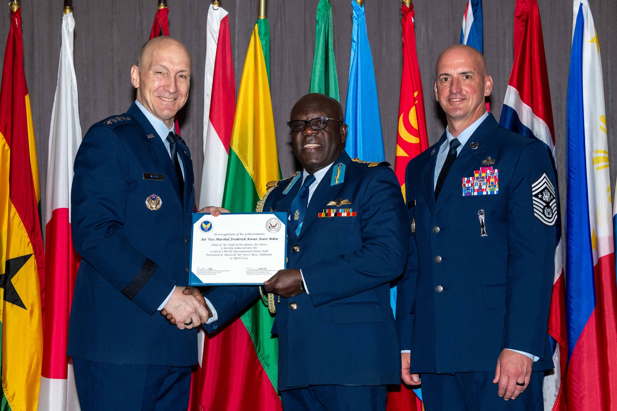 Air Force Chief of Staff Gen. David Allvin and Chief Master Sergeant of the Air Force David Flosi Air Vice Marshal Frederick Kwasi Asare Bekoe, Chief of Air Staff of the Ghana Air Force into the 2024 CSAF & CMSAF International Honor Roll at Maxwell Air Force Base, Ala., Apr. 19, 2024. International Honor Roll recognizes former Air University students who rose to the equivalent level of Chief of Staff or higher or Chief Master Sergeant of the Air Force or higher in their respective services. (US Air Force photo by Melanie Rodgers Cox)