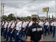 NMMI Cadet stands at parade rest while watching Soldiers march by during a parade