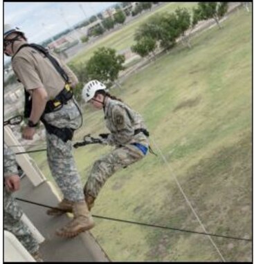 Female cadet in Army uniform reppelling off a rappel tower