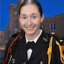 NMMI Cadet in formal uniform poses before a school building