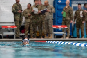Capt. Tiffany Marzette attempts the 100-meter swim while in uniform.