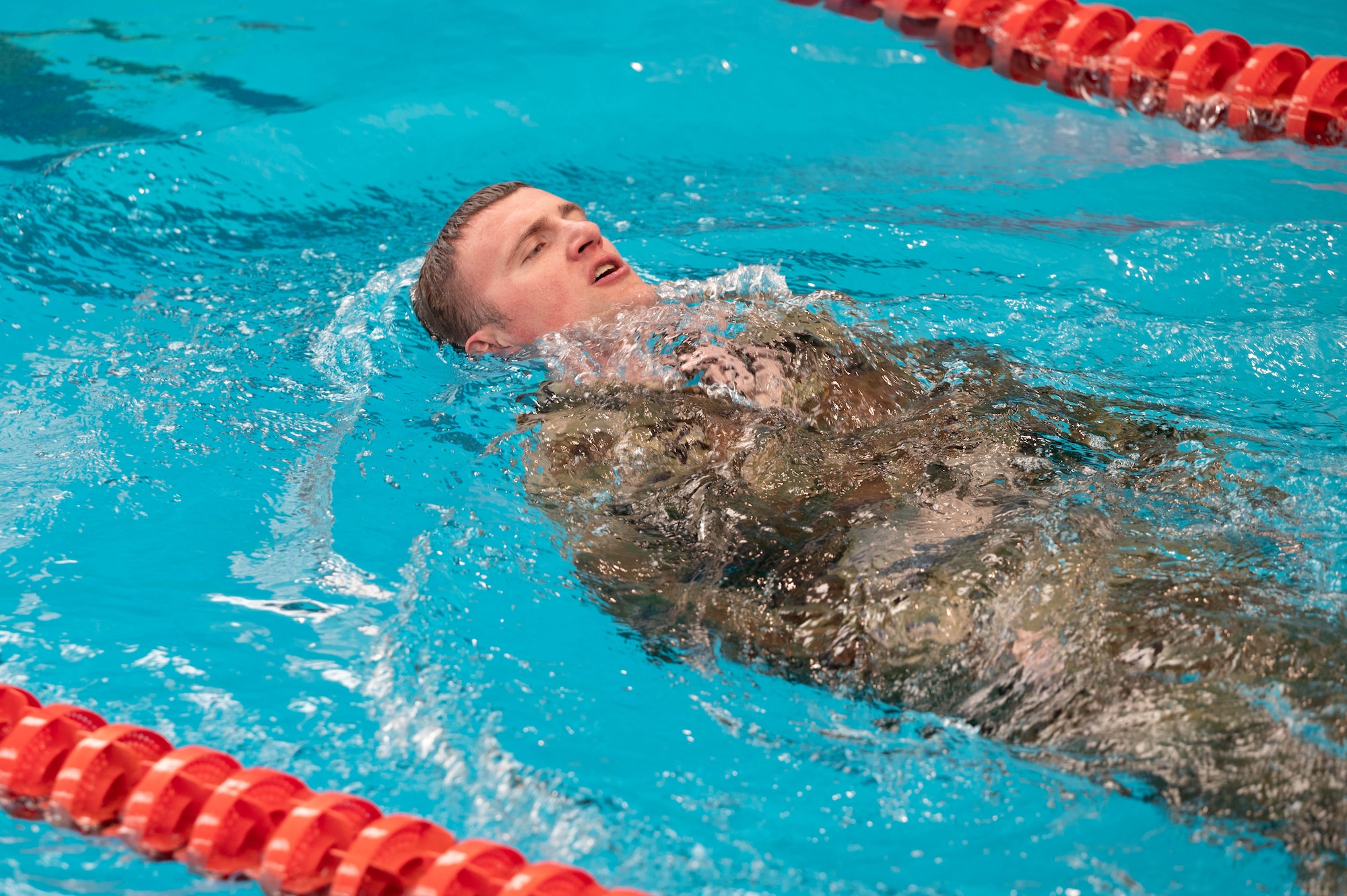 Maj. Joshua William attempts the 100-meter swim and will have to take off his uniform while in the water without aid and without touching the walls of the pool, while wearing a swimsuit underneath.