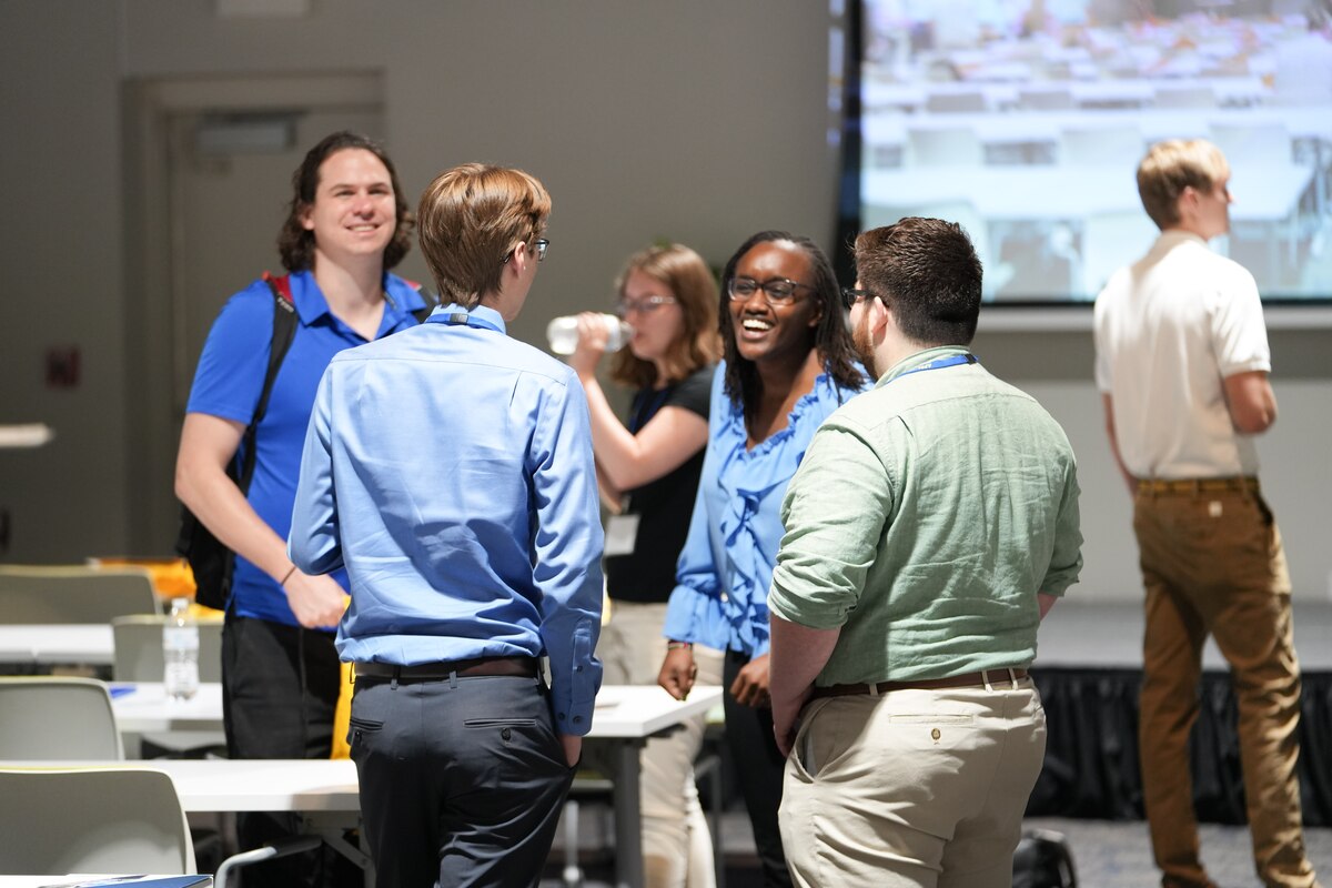 Wanjiku (Ciku) Makumi greets fellow Air Force Research Laboratory Scholars at the 2023 AFRL Scholar Orientation hosted by AFRL’s Munitions Directorate at the Doolittle Institute in Niceville, Florida, June 5, 2023. The AFRL Scholars Program is a paid internship program designed for students pursuing graduate level STEM degrees and offers immersive, hands-on experiences in the field under the mentorship of AFRL subject matter experts. (U.S. Air Force photo / Chris Quinlin)