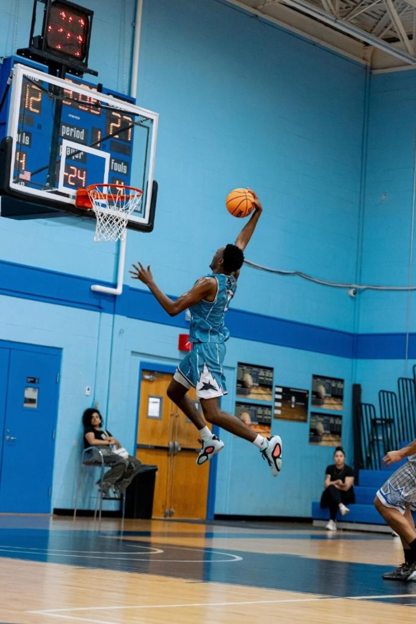 U.S. Air Force Airman, Jakevan Leftridge, jumps to dunk a basketball during the National Military Basketball Tournament.