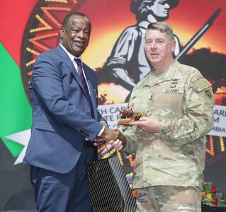 Maj. Gen. Todd Hunt, the adjutant general of North Carolina, joins Kristi Jones, chief of staff for the North Carolina governor’s office; the Honorable Ambrose Lwizhi Lufuma, member of Parliament, minister of defence, Republic of Zambia; and Honorable Jack Mwiimbu, SC, member of Parliament, minister of home affairs and internal security for a State Partnership Program signing ceremony in Livingstone, Zambia, April 26, 2024.