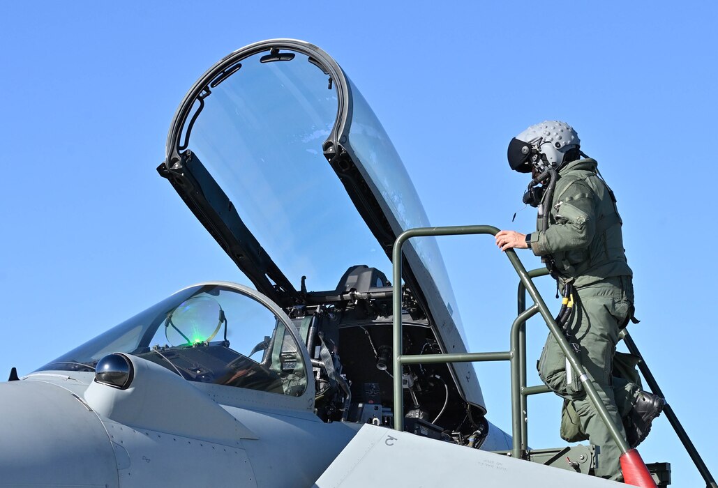 An Italian Air Force pilot boards his aircraft during and exercise.