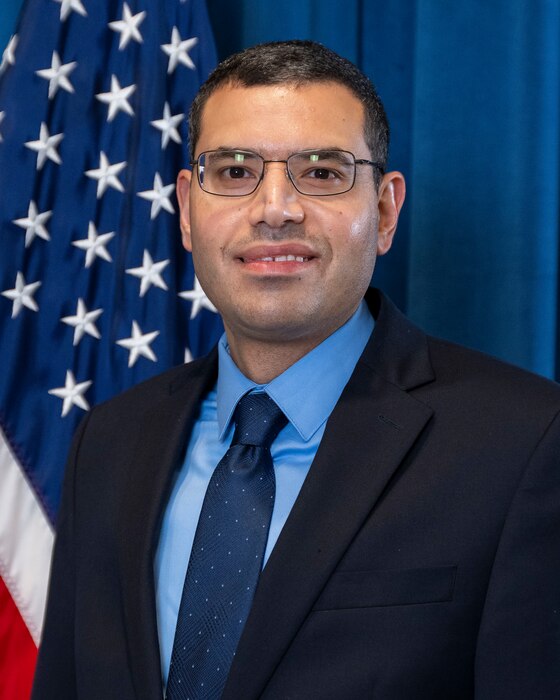 Man in front of flag