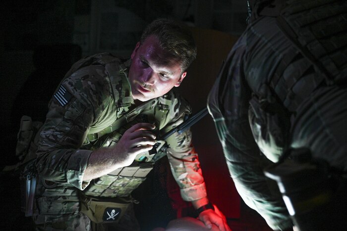 An Airman holds a flashlight