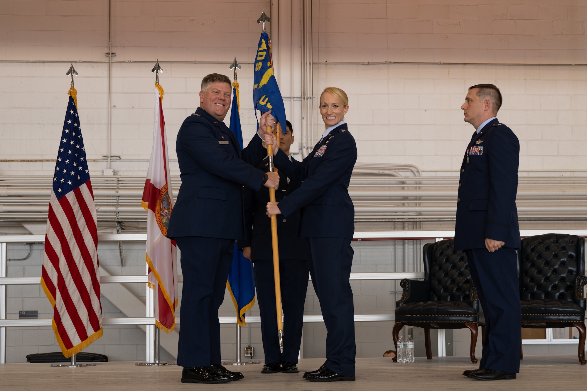 U.S. Air Force Col. Adam E. Moore, the 1st Special Operations Group commander, left, presents the guidon to Lt. Col Caitlin Reilly, the 319th Special Operations Squadrons commander, during the 319th SOS change of command and reassignment ceremony at Hurlburt Field, Florida, May 3, 2024. The reassignment of the 319th SOS from the 1st Special Operations Wing to the 492d Special Operations Wing will help Air Force Special Operations Command deploy and sustain power in support of the National Defense Strategy. (U.S. Air Force photo by Senior Airman Hussein Enaya)