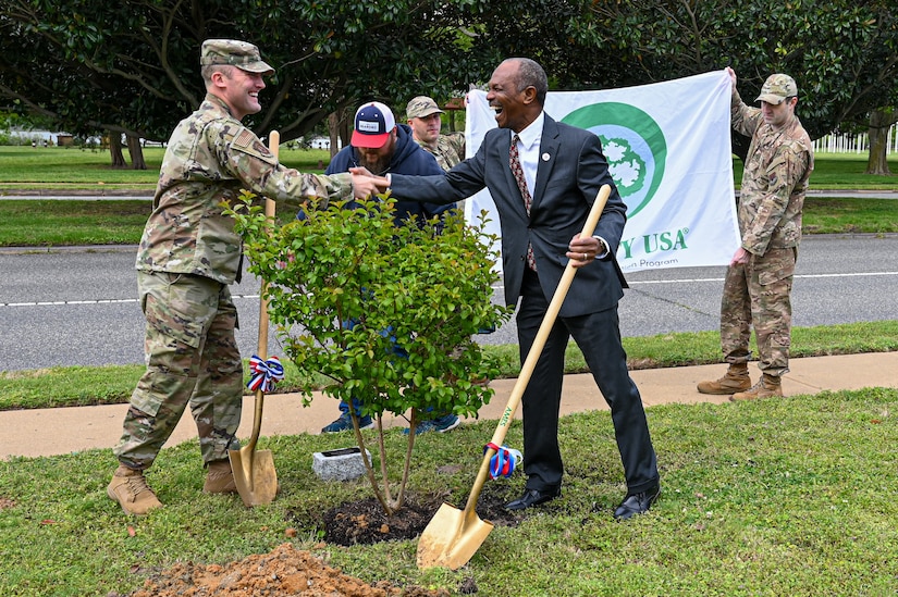 U.S. Air Force Col. Matthew Altman, 633d Air Base Wing commander, left, shakes hands with Donnie Tuck, City of Hampton mayor, at Joint Base Langley-Eustis, Virginia, April 22, 2024. In collaboration with local officials, JBLE commemorated Arbor Day by planting trees on base to enrich the landscape. (U.S. Air Force photo by Airman 1st Class Skylar Ellis)