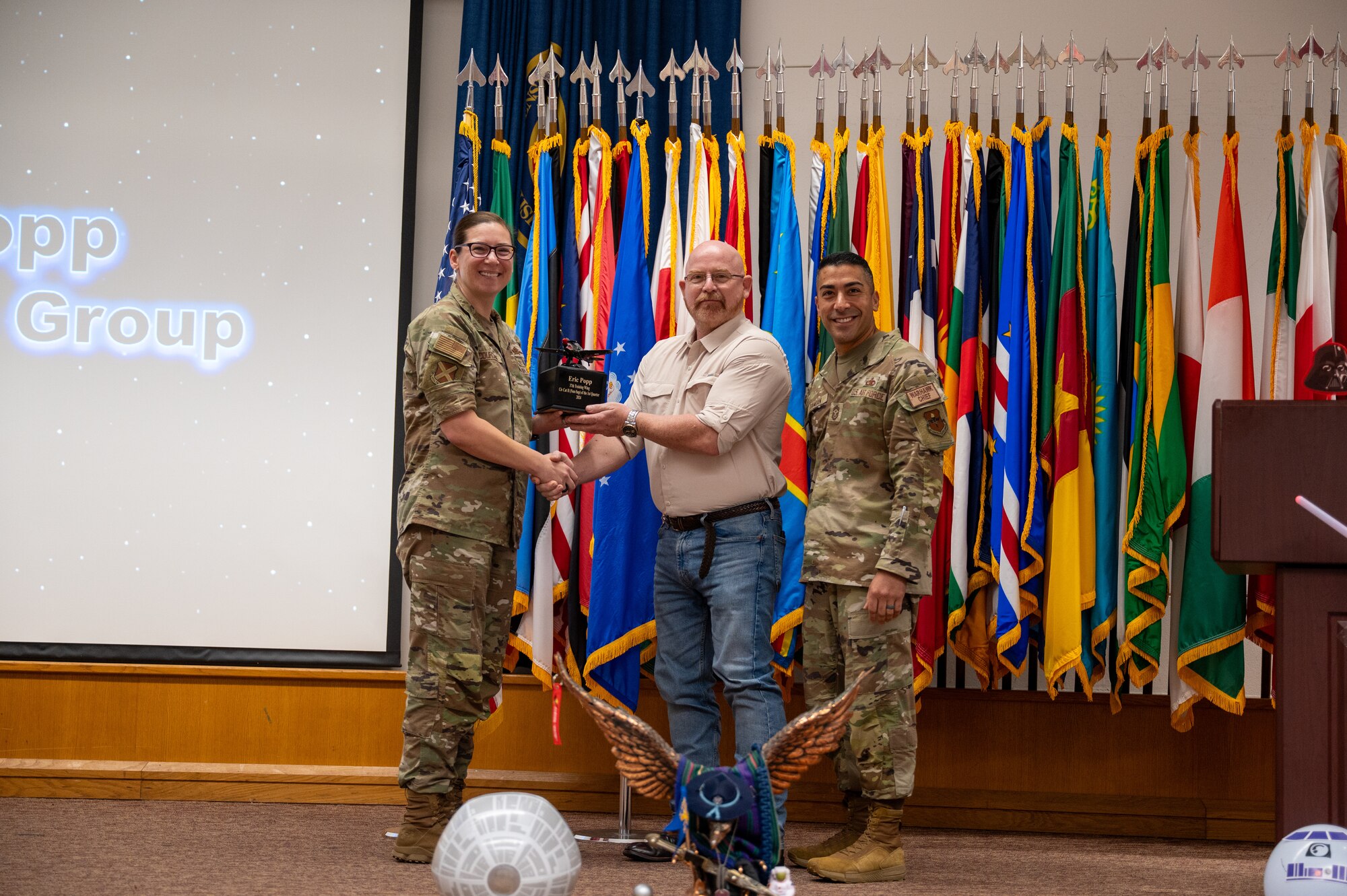 The 37th Training Wing Commander Colonel Lauren Courchaine presents members of the 37th Training Wing with a first quarter award on May 3, 2024. Members from the 37th Training Group, Inter-American Air Forces Academy, 637th Training Group and 737th Training Group were represented during the award ceremony. (U.S. Air Force photo by 2nd Lt. Kate Anderson)