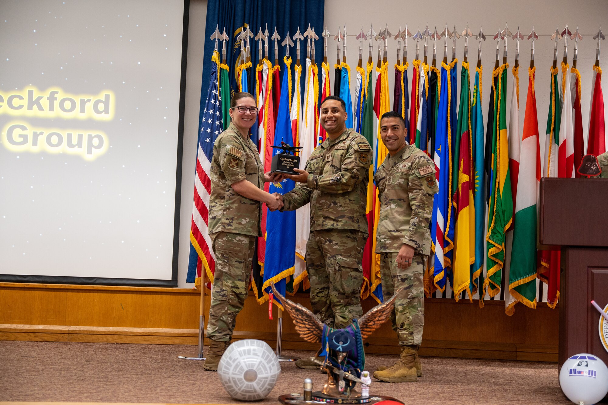 The 37th Training Wing Commander Colonel Lauren Courchaine presents members of the 37th Training Wing with a first quarter award on May 3, 2024. Members from the 37th Training Group, Inter-American Air Forces Academy, 637th Training Group and 737th Training Group were represented during the award ceremony. (U.S. Air Force photo by 2nd Lt. Kate Anderson)