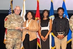 The Alexander Family receives the Outstanding Family Volunteer of the Year award from U.S. Army Lt. Gen. John R. Evans Jr., commander, U.S. Army North (Fifth Army), at the Joint Base San Antonio 2023 Volunteer awards ceremony, JBSA-Fort Sam Houston, Texas, April 17, 2024. (U.S. Air Force photo by Kara Carrier)