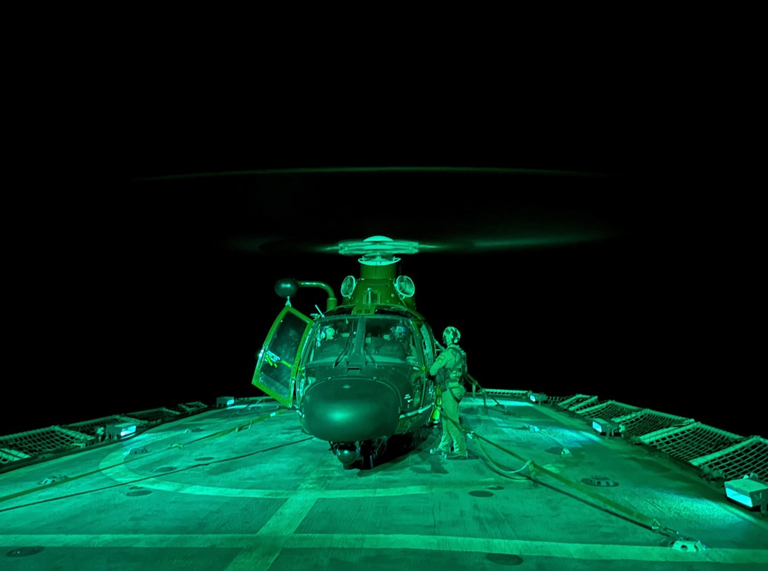 An aircrew from the Helicopter Interdiction Squadron (HITRON) aboard an MH-65 Dolphin performs night vision goggle deck landing qualifications aboard the USCGC Active (WMEC 618) while patrolling the Eastern Pacific Ocean, Apr. 15, 2024. The Jacksonville, Florida-based HITRON consists of crews specially trained to use airborne force to stop vessels suspected of breaking U.S. and international laws on the high seas. U.S. Coast Guard photo by Ens. Thomas Gehman.