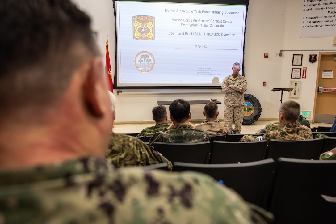 U.S. Marine Corps Maj. Gen. Thomas B. Savage, a Chico, California native, commanding general of Marine Air-Ground Task Force Training Command, Marine Corps Air-Ground Combat Center, welcomes foreign naval attachés of various nations to MCAGCC, Twentynine Palms, California, April 25, 2024. The purpose of the visit was to introduce the attachés to Department of the Navy capabilities and build cohesion amongst their countries and the U.S. Navy. (U.S. Marine Corps photo by Cpl. Jonathan Willcox)