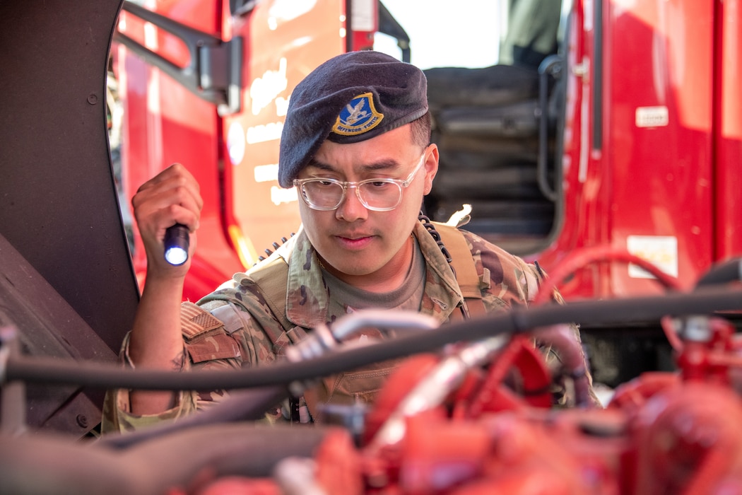 Security Forces defender inspects a truck.