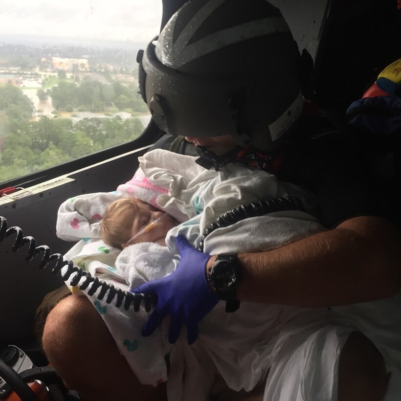 A Coast Guard aircrew assists infant during the aftermath of Hurricane Harvey in the greater Houston Metro Area Aug. 29, 2017. The Coast Guard has pulled assets and resources from across the country to create a sustainable response force.

U.S. Coast Guard photo by Petty Officer 2nd Class Chase Redditt.