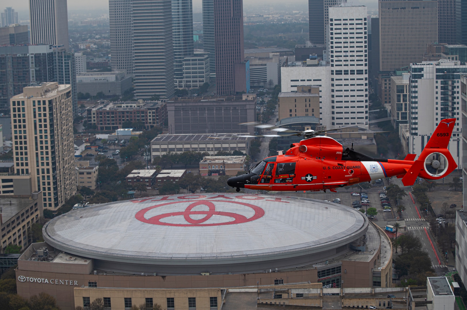 Coast Guard Air Station Houston performs an area of responsibility formation flight over the Toyota Center in Houston, Texas, March 11, 2022. The air station regularly conducts AOR runs to keep crews familiar with the area. (U.S. Coast Guard photo by Petty Officer 3rd Class Alejandro Rivera)