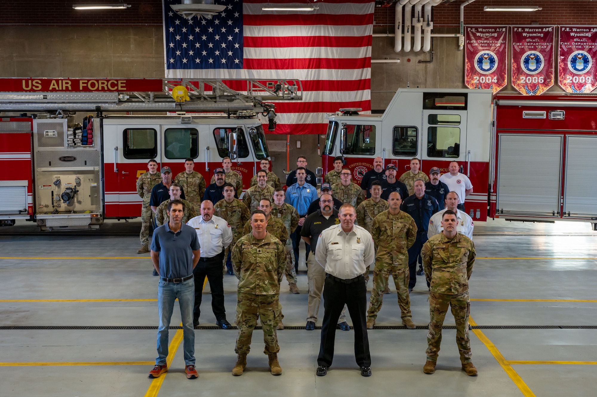 group photo in front of fire trucks