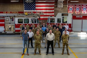 group photo in front of fire trucks