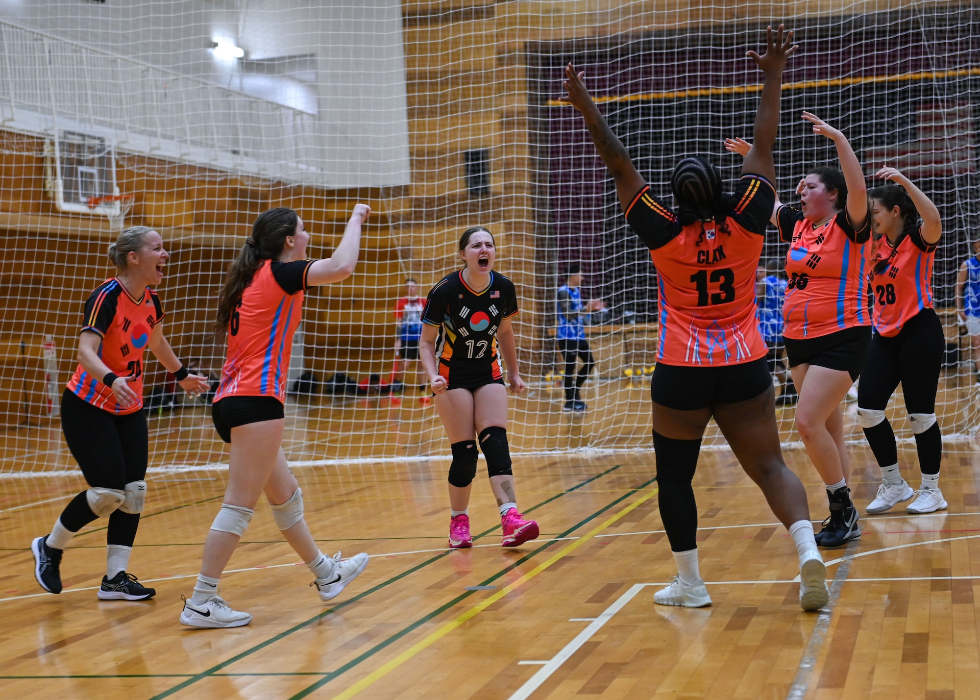 Osan Air Base Varsity Volleyball members on Vixen 1 celebrate after winning a point during a volleyball set at the 2024 INDOPACOM Volleyball Tournament at Yokota AB, Japan, April 27, 2024. Osan AB Varsity Volleyball formed two women’s teams, Vixen 1 and Vixen 2, that competed in the tournament. A member from Vixen 1, Senior Airman Desiree Claxton, 51st Security Forces Squadron unit scheduler, received the most valuable player award out of all the women in the tournament. (U.S. Air Force photo by Staff Sgt. Aubree Owens)