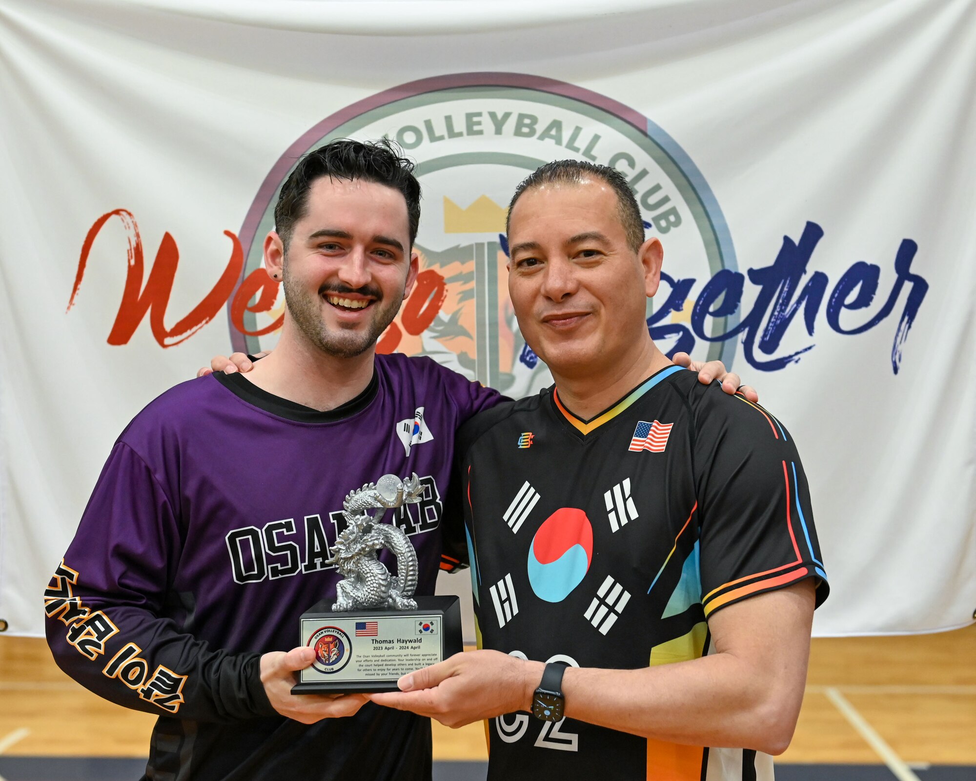 U.S. Air Force Lt. Col. Carlos Colon, right, 7th Air Force Manpower, Personnel and Services director and Osan Air Base Varsity Volleyball coach, presents a plaque of appreciation to Senior Airman Thomas Haywald, 51st Logistics Readiness Squadron logistics planner, at the 2024 INDOPACOM Volleyball Tournament at Yokota AB, Japan, April 27, 2024. Haywald has been an active member of Osan AB Varsity Volleyball for 12 months, leading practices, open gyms and finding local competition for scrimmages. Additionally, Haywald was the 51st Fighter Wing’s lead organizer for Osan AB team members to attend the tournament hosted by Yokota AB. (U.S. Air Force photo by Staff Sgt. Aubree Owens)