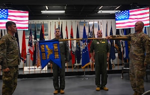 The guidon for the newly reactivated 388th Electronic Warfare Squadron is unfurled during its reactivation ceremony at the U.S. Air Force Armament Museum, Eglin Air Force Base, Florida, May 2, 2024. The 388th EWS previously served as the 388th Electronic Combat Squadron and operated the EA-6B Growler, before being deactivated in 2010. (U.S. Air Force photo by Capt. Benjamin Aronson)