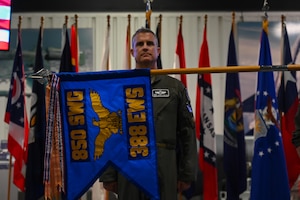 U.S. Air Force Col. Andrew Finkler, 850th Spectrum Warfare Wing commander, stands at attention as the guidon for the 388th Electronic Warfare Squadron is unfurled during a reactivation ceremony and assumption of command at the U.S. Air Force Armament Museum, Eglin Air Force Base, Florida, May 2, 2024. The 388th EWS will focus on ensuring electromagnetic warfare capabilities can be effectively integrated into joint force planning. (U.S. Air Force photo by Capt. Benjamin Aronson)