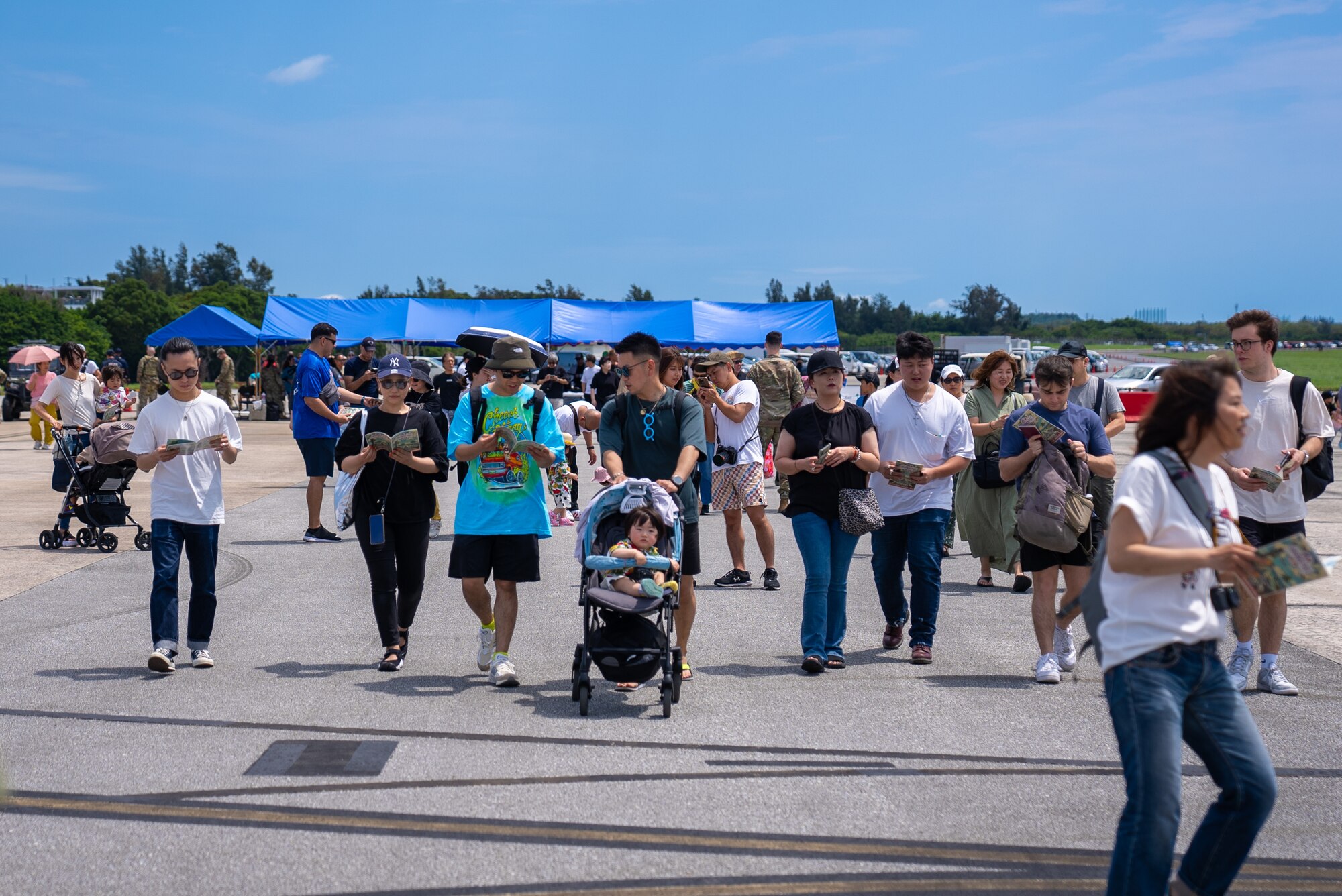 Festival attendees make their way onto the flightline for America Fest at Kadena Air Base, Japan, April 27, 2024.
