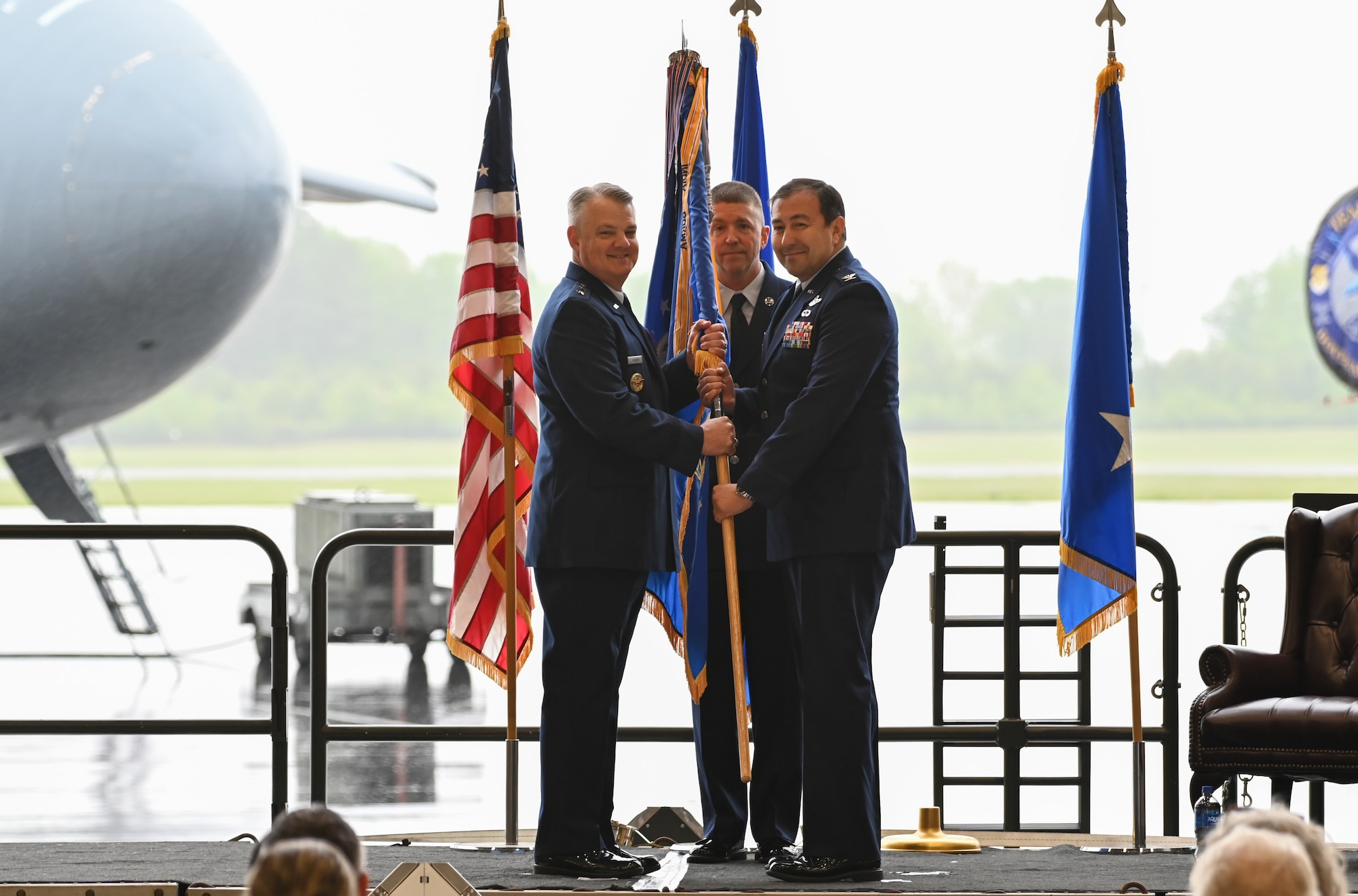 Maj. Gen. D. Scott Durham, 4th Air Force commander, March Air Force Base, California, passes the 512th Airlift Wing guidon to Col. Eric J. Rivero during an assumption of command ceremony on Dover Air Force Base, Delaware, May 4, 2024.