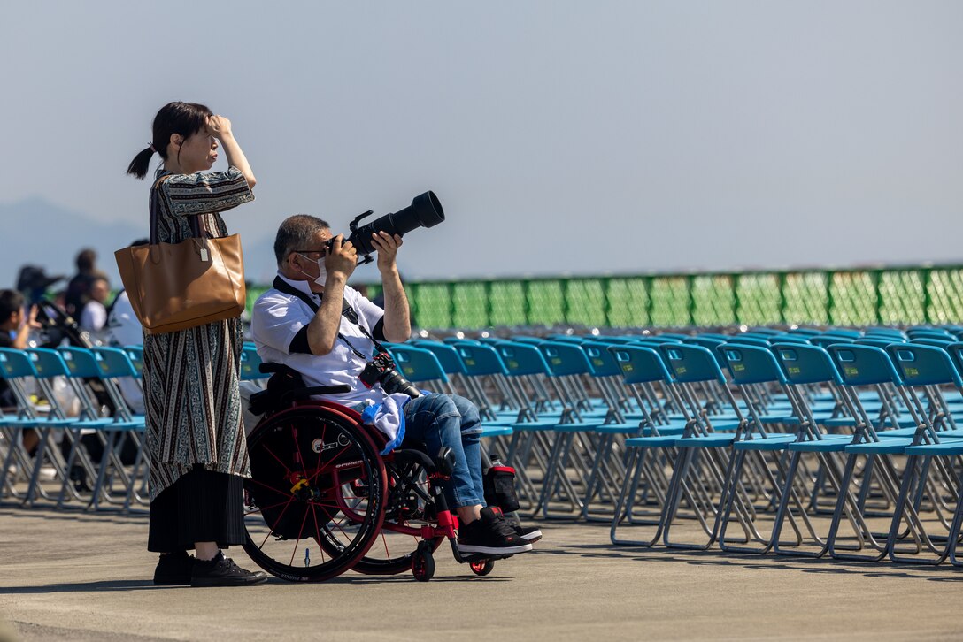 Visitors of Marine Corps Air Station Iwakuni’s Family Day air show take photos of passing aircraft at MCAS Iwakuni, Japan, May 4, 2024. This first iteration of Family Day and Inclusive Day at MCAS Iwakuni allowed both U.S. and Japanese members of the MCAS Iwakuni community, their family members, local orphanages, and members of the local community with special needs the ability to experience a small-scale Friendship Day during the air show rehearsal that showcased the strength of the U.S.-Japan alliance. (U.S. Marine Corps photo by Cpl. Calah Thompson)