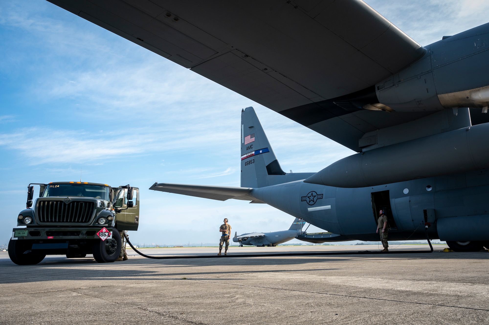 Air Force members from the 18th Logistics Readiness Squadron provide fuel to a C-130J Hercules before takeoff .