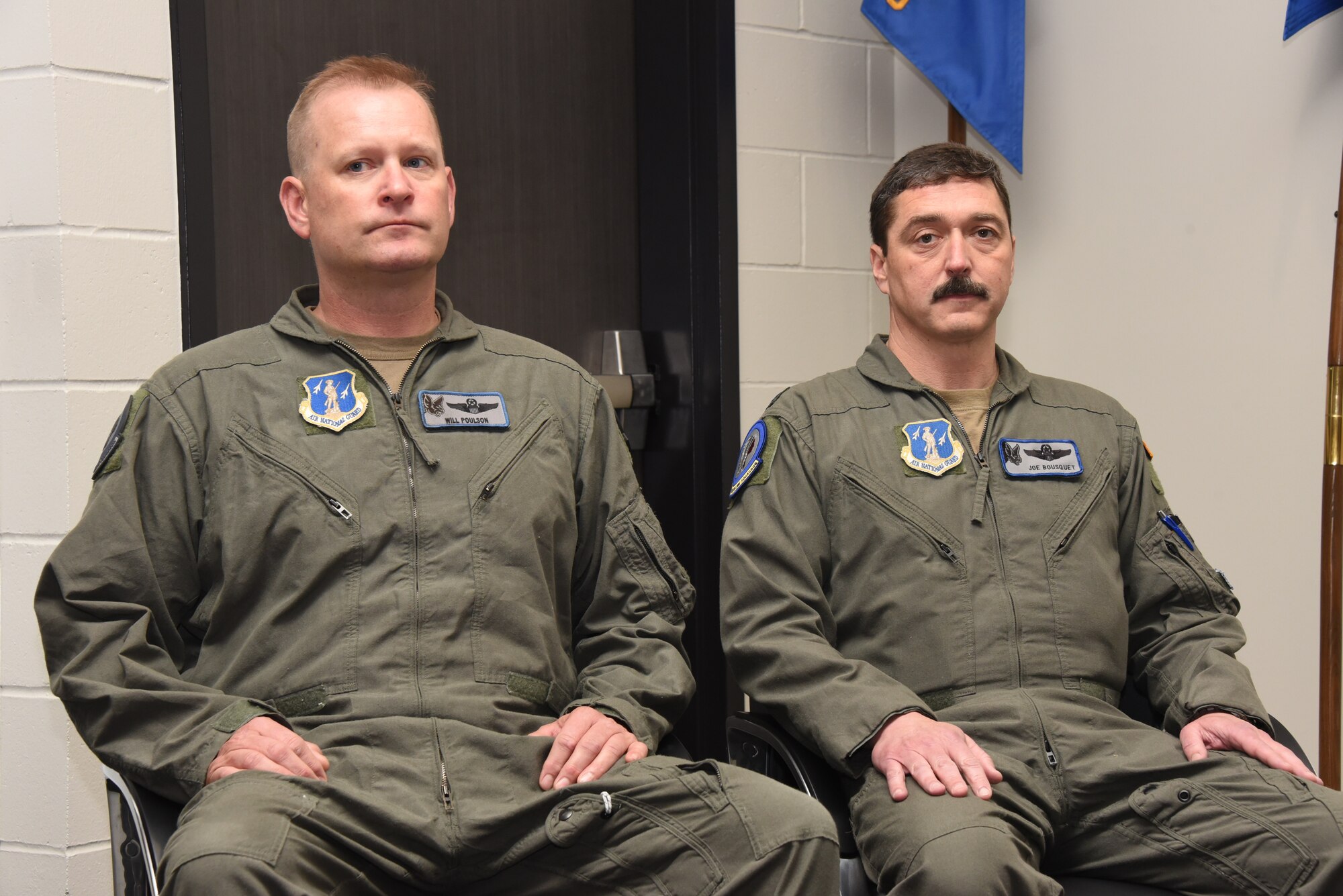 Lt. Col. William Poulson, outgoing 174th Air Refueling Squadron Commander, left, sits next to Lt. Col. Joseph Bousquet, the incoming 174th ARS Commander