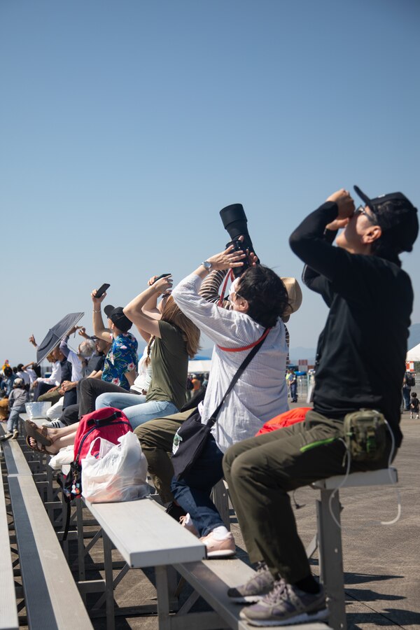 Guests watch an aerial demonstration during the inaugural Family Day and Friendship Day at Marine Corps Air Station Iwakuni, Japan, May 4, 2024. This first iteration of Family Day and Inclusive Day at MCAS Iwakuni allowed both U.S. and Japanese members of the MCAS Iwakuni community, their family members, local orphanages, and members of the local community with special needs the ability to experience a small-scale Friendship Day during the air show rehearsal that showcased the strength of the U.S.-Japan alliance.(U.S. Marine Corps photo by Lance Cpl. Rylan Adcock.)