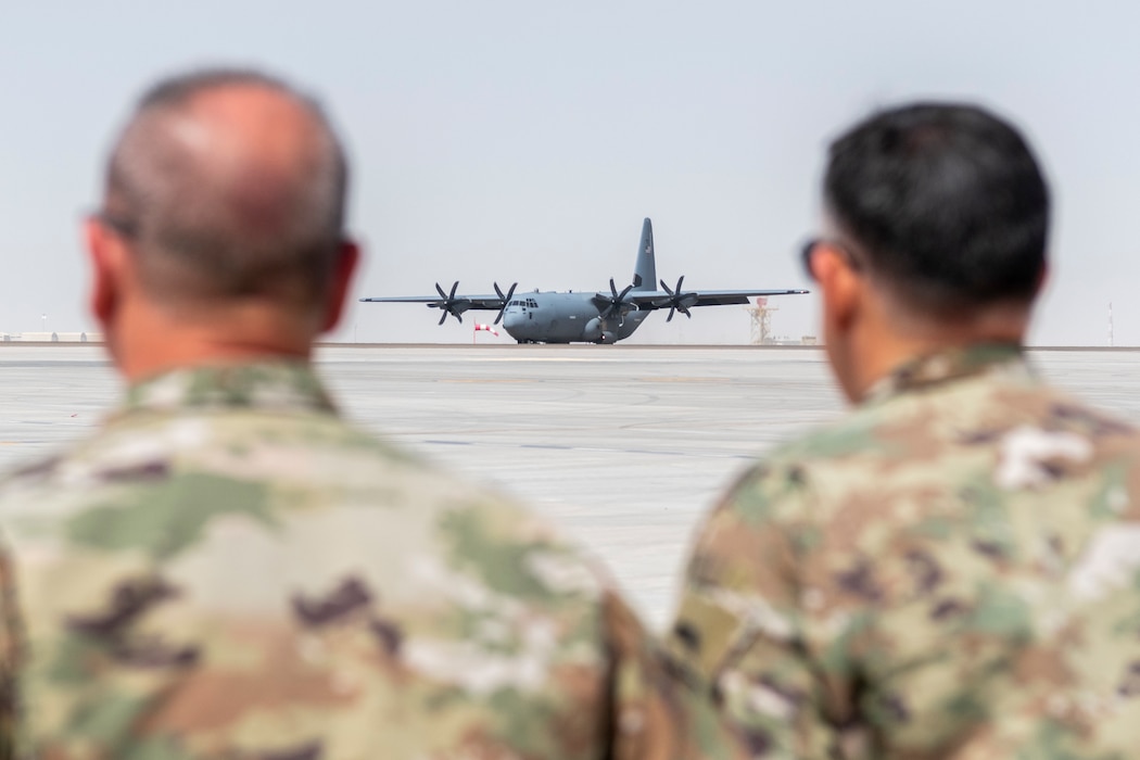 U.S. Air Force Col. Ronald Selvidge, 380th Air Expeditionary Wing commander, and Chief Master Sgt. James Cutshaw, 380th AEW command chief, watch as a C-130 carrying Lt. Gen. Derek France, commander of Ninth Air Force, taxi after landing at an undisclosed location within the U.S. Central Command area of responsibility, April 29, 2024. France, who recently took command of Ninth Air Force, visited the wing to get a better understanding of its current operational capabilities, better enabling him to make informed decisions throughout the region. (U.S. Air Force photo)