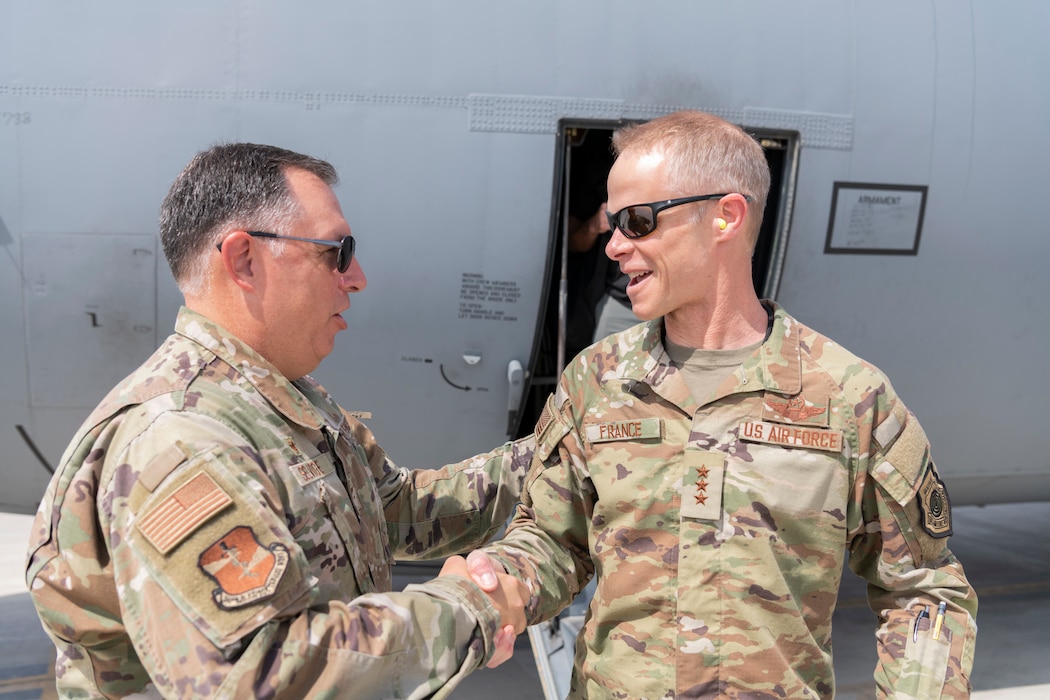 U.S. Air Force Lt. Gen. Derek France, Ninth Air Force commander, shakes hands with Col. Ronald Selvidge, 380th Air Expeditionary Wing commander, during a visit to the 380th AEW at an undisclosed location within the U.S. Central Command area of responsibility, April 29, 2024. France, who recently took command of Ninth Air Force, visited the wing to get a better understanding of its current operational capabilities, better enabling him to make informed decisions throughout the region. (U.S. Air Force photo)