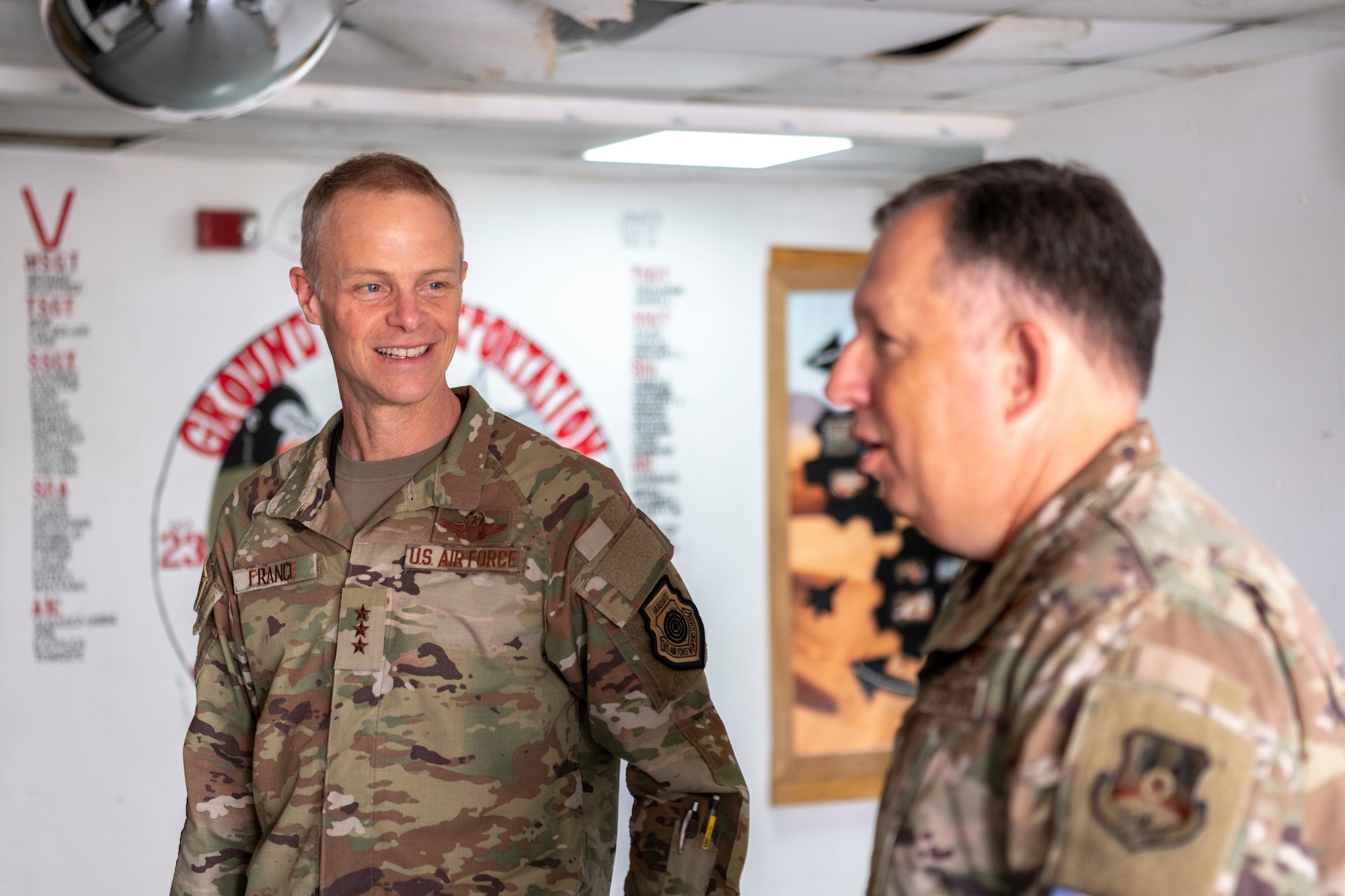 U.S. Air Force Lt. Gen. Derek France, Ninth Air Force commander, speaks with Col. Ronald Selvidge, 380th Air Expeditionary Wing commander, about damage done during a severe storm at an undisclosed location within the U.S. Central Command area of responsibility, April 29, 2024. France, who recently took command of Ninth Air Force, visited the wing to get a better understanding of its current operational capabilities, better enabling him to make informed decisions throughout the region. (U.S. Air Force photo)